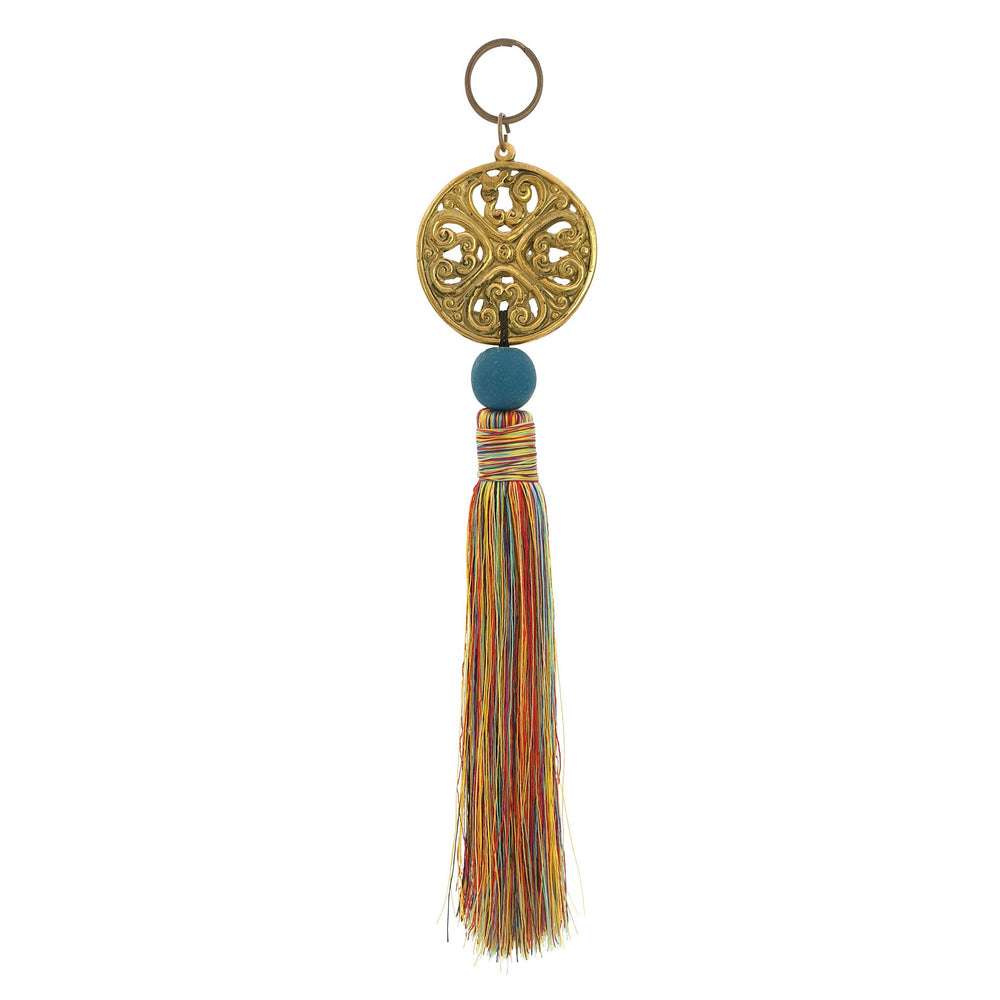 Keychain with metal ornament in gold color and mix red tassel