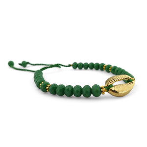 
                  
                    Load image into Gallery viewer, Bracelet with green crystals and gold brass shell side view
                  
                