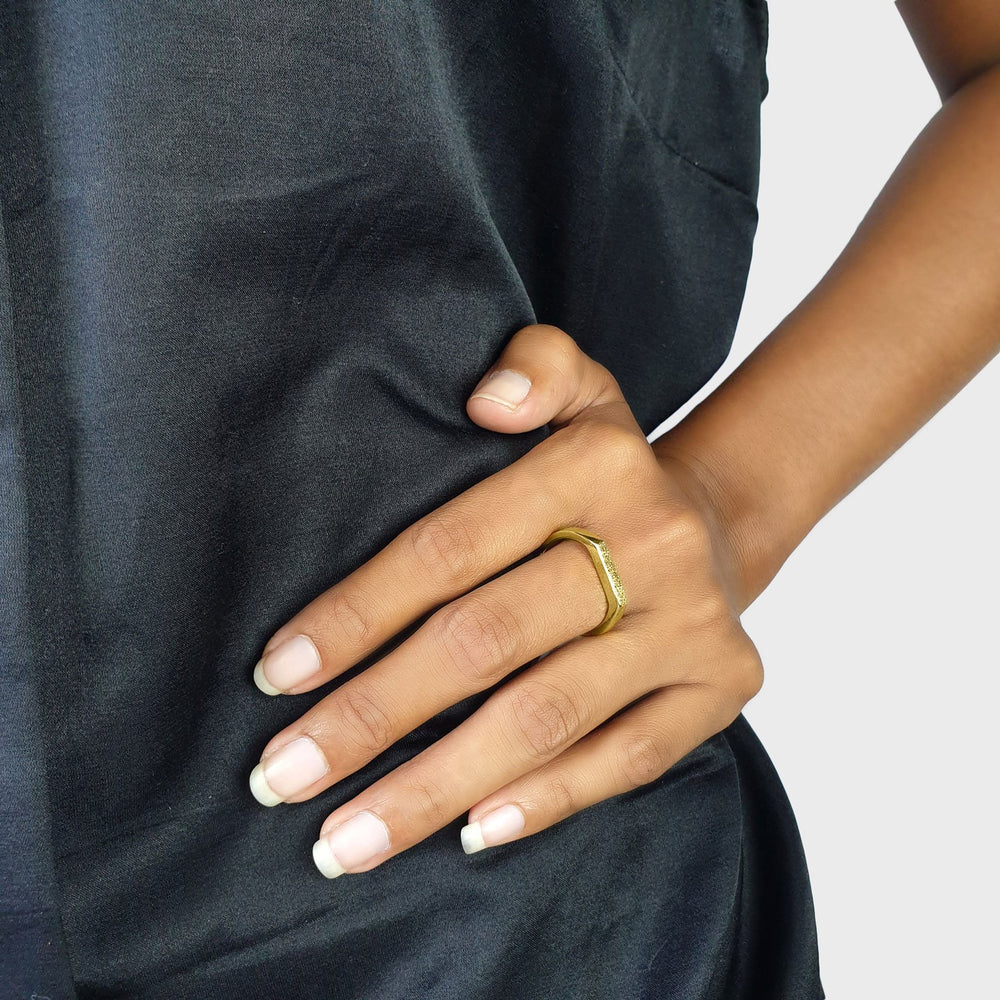 
                  
                    Load image into Gallery viewer, Brass gold color ring with flat and hammered front surface on model
                  
                