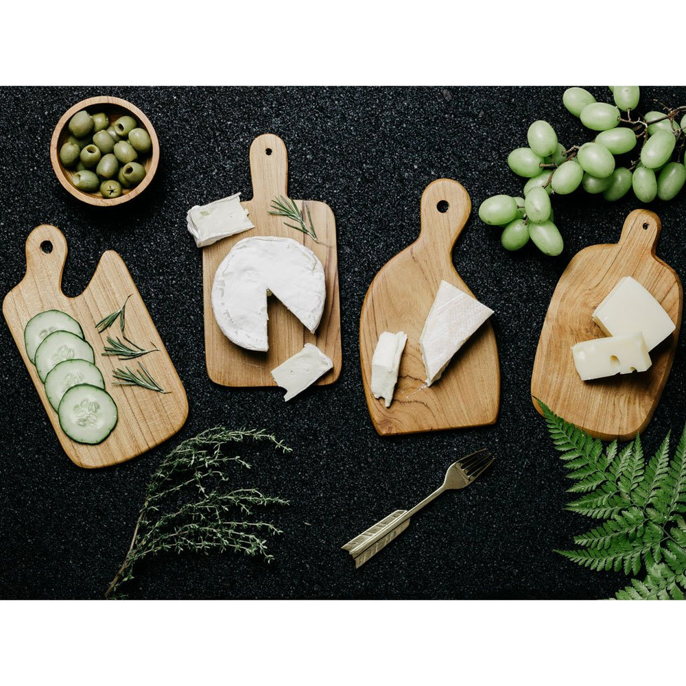 Set of Wooden cheese boards in 4 different shapes made of teak with food