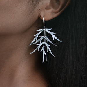 
                  
                    Load image into Gallery viewer, Earring Bamboo Leaf silver plated on model
                  
                
