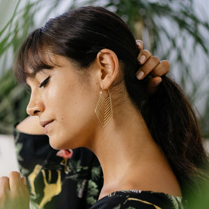 
                  
                    Load image into Gallery viewer, Brass earring tribal lines on model
                  
                